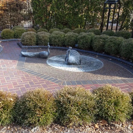 Paved garden area with decorative stones and shrubs